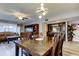 A dining room with an open floor plan features modern lighting and leads to a living room with outdoor access at 700 Starkey Rd # 1216, Largo, FL 33771