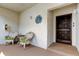 Inviting front porch features two wicker chairs with green cushions at 700 Starkey Rd # 1216, Largo, FL 33771