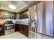 Kitchen featuring stainless steel appliances, dark wood cabinetry, and stylish backsplash at 700 Starkey Rd # 1216, Largo, FL 33771