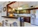 A kitchen with a breakfast bar has updated countertops, cabinets, and stainless steel appliances at 700 Starkey Rd # 1216, Largo, FL 33771
