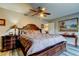 This bedroom showcases a large bed, ceiling fan, and warm lighting, creating a relaxing atmosphere at 700 Starkey Rd # 1216, Largo, FL 33771