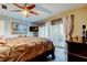 Bright bedroom with ceiling fan, outdoor access, and natural light enhances this charming space at 700 Starkey Rd # 1216, Largo, FL 33771