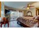 Stylish main bedroom features patio access, a ceiling fan, and wood-look flooring at 700 Starkey Rd # 1216, Largo, FL 33771