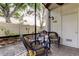 Comfortable screened porch featuring wicker chairs, side tables, and a tranquil backyard view at 700 Starkey Rd # 1216, Largo, FL 33771