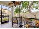 Relaxing screened porch with ceiling fan, wicker furniture, and a view of the private yard at 700 Starkey Rd # 1216, Largo, FL 33771