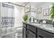 Well-lit bathroom featuring granite countertops, framed botanical artwork and a tub with shower at 7030 Summer Holly Pl, Riverview, FL 33578