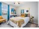 Bright bedroom featuring a ceiling fan, large window, chair and stylish decor creating a comforting retreat at 7030 Summer Holly Pl, Riverview, FL 33578