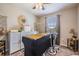 Clean bedroom with soft, natural light features a ceiling fan, spa table, neutral tones, and decor at 7030 Summer Holly Pl, Riverview, FL 33578