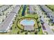 Aerial view of a community pool surrounded by townhomes and a canal at 7030 Summer Holly Pl, Riverview, FL 33578