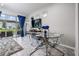 Dining area featuring a glass table set with chairs, TV and backyard view at 7030 Summer Holly Pl, Riverview, FL 33578