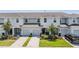 Charming townhome featuring well-maintained landscaping, a private garage, and an inviting entrance at 7030 Summer Holly Pl, Riverview, FL 33578
