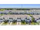 Expansive aerial shot showcases a community of townhomes with neat landscaping and organized parking at 7030 Summer Holly Pl, Riverview, FL 33578