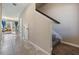 Hallway with ceramic floors that leads into a seating area and includes stairs going to the second level at 7030 Summer Holly Pl, Riverview, FL 33578