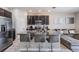 Stylish kitchen with a large island, granite counters, and stainless steel appliances at 7030 Summer Holly Pl, Riverview, FL 33578