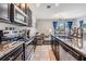 Modern kitchen featuring stainless steel appliances and an open view to the living area at 7030 Summer Holly Pl, Riverview, FL 33578