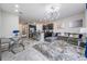 A bright living room with modern decor, an open concept, and stylish furniture and kitchen at 7030 Summer Holly Pl, Riverview, FL 33578