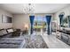 Comfortable living room with lots of light from sliding glass doors overlooking the backyard at 7030 Summer Holly Pl, Riverview, FL 33578