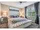 Elegant main bedroom with tufted headboard, soft lighting, and a serene ambiance at 7030 Summer Holly Pl, Riverview, FL 33578