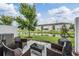 Outdoor patio with wicker furniture and a serene view of the pond at 7030 Summer Holly Pl, Riverview, FL 33578