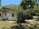 Backyard of home with lattice porch, AC unit, and shaded area offering outdoor comfort at 7601 Pine Hill Dr, Tampa, FL 33617