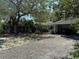 Lovely single-story home with a covered carport, lush landscaping, and a welcoming front entrance at 7601 Pine Hill Dr, Tampa, FL 33617