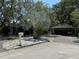 Charming single-story home featuring mature landscaping, a covered carport, and a classic white mailbox at 7601 Pine Hill Dr, Tampa, FL 33617