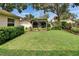 Lush backyard featuring a hammock under a pergola with mature trees and landscaping at 905 Balsamina Dr, Brandon, FL 33510