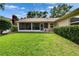 Lush backyard and screened-in porch provide a comfortable outdoor retreat at 905 Balsamina Dr, Brandon, FL 33510