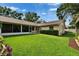 Lush backyard with a screened-in porch offers a serene outdoor living experience at 905 Balsamina Dr, Brandon, FL 33510