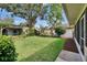 A well-manicured backyard featuring a hammock in a pergola on a sunny day at 905 Balsamina Dr, Brandon, FL 33510