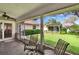 Secluded backyard view from screened-in patio featuring a pergola with a hammock at 905 Balsamina Dr, Brandon, FL 33510