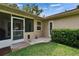 View of screened-in porch and backyard with grass and mature landscaping at 905 Balsamina Dr, Brandon, FL 33510