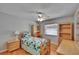 Cozy bedroom with hardwood floors, ceiling fan, and ample natural light from the window at 905 Balsamina Dr, Brandon, FL 33510