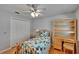 Comfortable bedroom features built-in shelving, a ceiling fan, and a closet for storage at 905 Balsamina Dr, Brandon, FL 33510