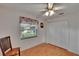 Bright bedroom with light wood floors, window, ceiling fan, and closet at 905 Balsamina Dr, Brandon, FL 33510