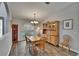 Dining room with wood floors, a large window, and classic wood furniture at 905 Balsamina Dr, Brandon, FL 33510