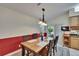 Charming dining area featuring wainscoting, vaulted ceiling, and sliding glass doors to the backyard at 905 Balsamina Dr, Brandon, FL 33510