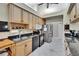 Functional kitchen boasts granite countertops, stainless steel appliances, and ample storage in light wood cabinetry at 905 Balsamina Dr, Brandon, FL 33510