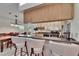 The kitchen features a breakfast bar, stainless steel appliances, and views to the dining and backyard at 905 Balsamina Dr, Brandon, FL 33510
