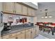 Open kitchen features stone countertops, an abundance of cabinets and a view of the fireplace at 905 Balsamina Dr, Brandon, FL 33510