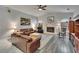 Open living room features a fireplace, wood floors, comfortable seating, and bright windows at 905 Balsamina Dr, Brandon, FL 33510
