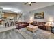 Open-concept living room boasts two leather sofas, decorative rug, and adjacent kitchen with bar seating at 905 Balsamina Dr, Brandon, FL 33510