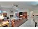 Spacious living room with a fireplace, tile flooring, and comfortable leather sofas at 905 Balsamina Dr, Brandon, FL 33510