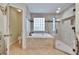 Beautiful bathroom with soaking tub, glass block window, and walk-in shower at 905 Balsamina Dr, Brandon, FL 33510