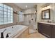 Updated bathroom boasts a soaking tub, glass block window, and walk-in shower at 905 Balsamina Dr, Brandon, FL 33510