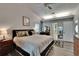 Bright main bedroom features a ceiling fan, wood floors, large dresser, and ensuite bathroom at 905 Balsamina Dr, Brandon, FL 33510