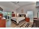 Bright main bedroom with wood floors, ceiling fan, and sliding glass door to outdoor patio at 905 Balsamina Dr, Brandon, FL 33510