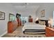 Spacious main bedroom with wood flooring, ceiling fan, tv, and two large dressers at 905 Balsamina Dr, Brandon, FL 33510