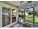 View from the screened patio to a grassy yard with a hammock under a pergola at 905 Balsamina Dr, Brandon, FL 33510