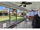 Relaxing screened patio with ceiling fans, outdoor seating, and barbecue grills overlooking the backyard at 905 Balsamina Dr, Brandon, FL 33510